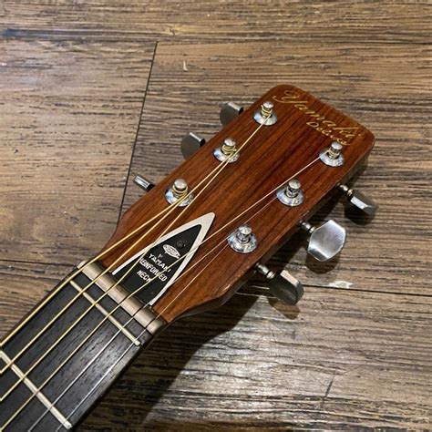 It has a solid red cedar top with rosewood back and sides. . Yamaki deluxe folk